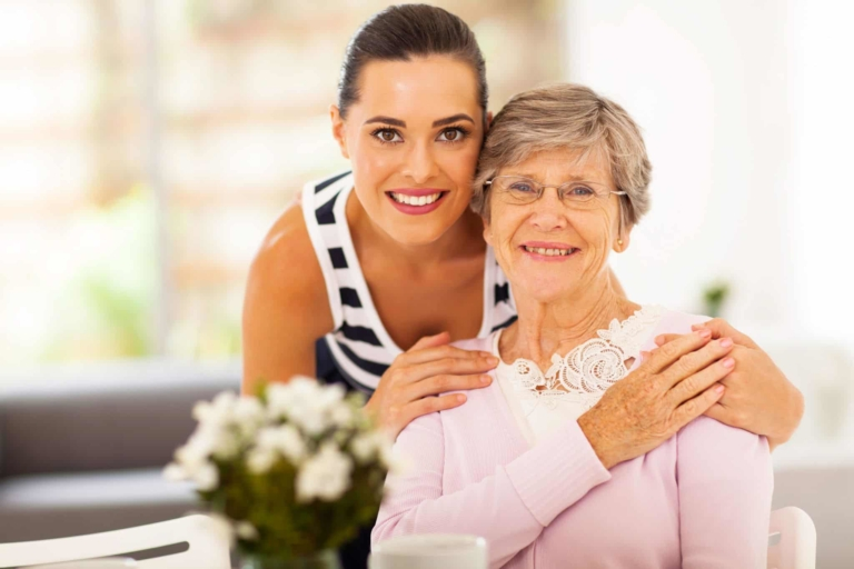 Nurse holding the hand of a palliative care client